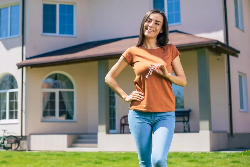 Woman in front of her new home