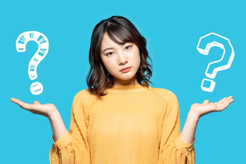 Woman holding question marks