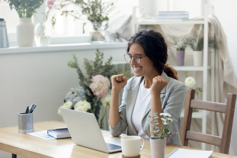 Woman excited using her computer
